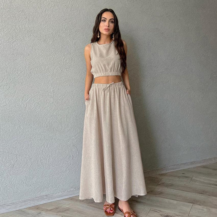 Woman wearing beige sleeveless crop top and matching wide-leg pants set posing indoors