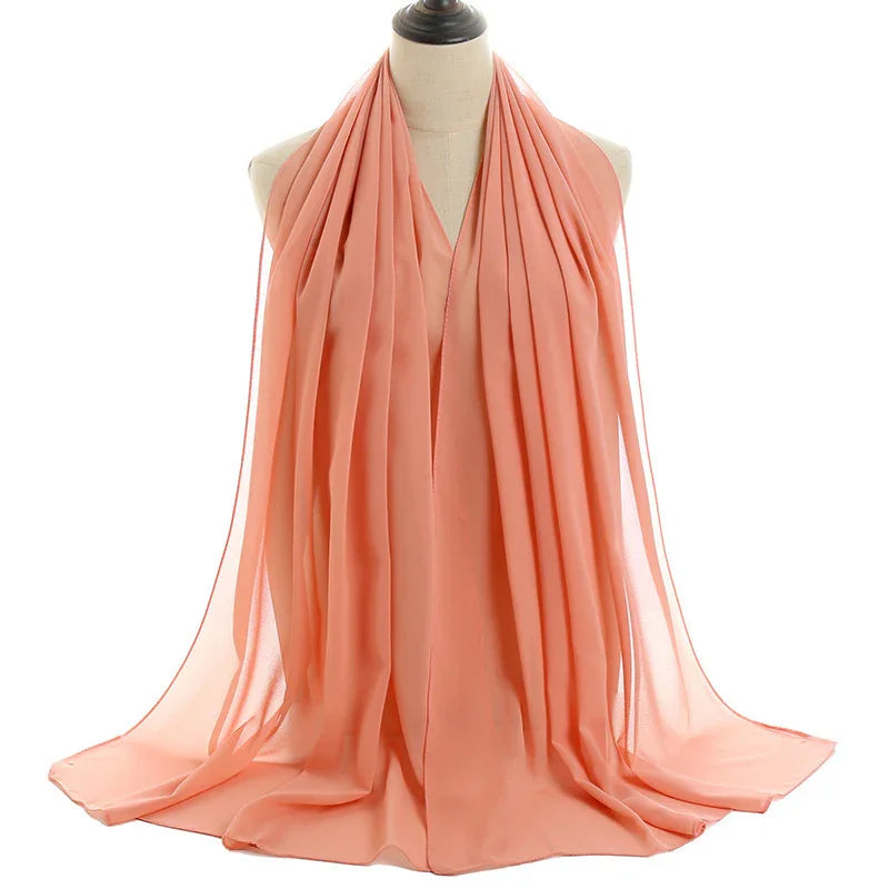 Light coral sheer chiffon scarf displayed on a dress form mannequin