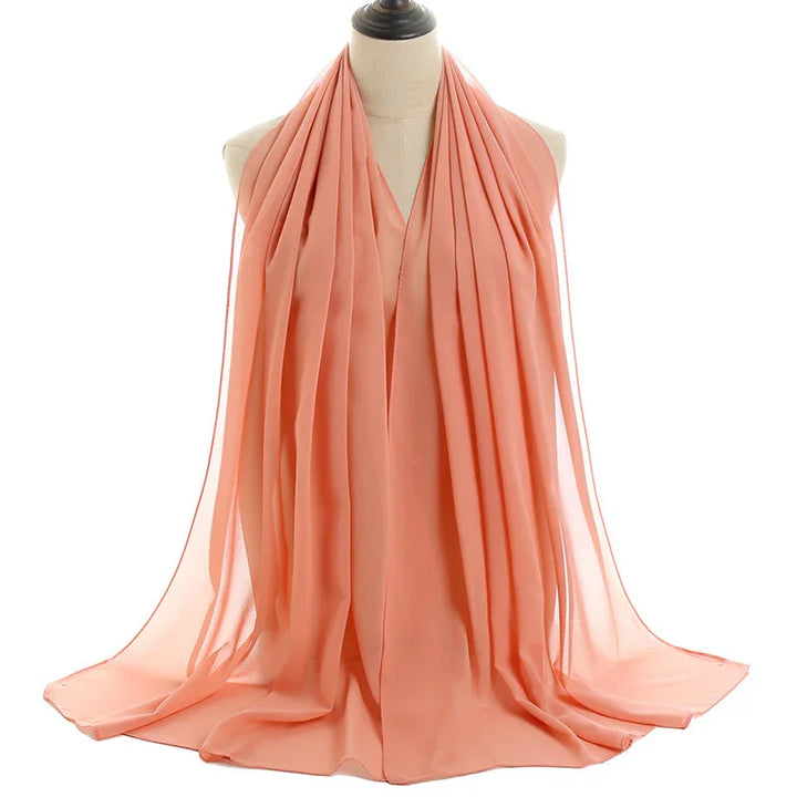 Light coral sheer chiffon scarf displayed on a dress form mannequin