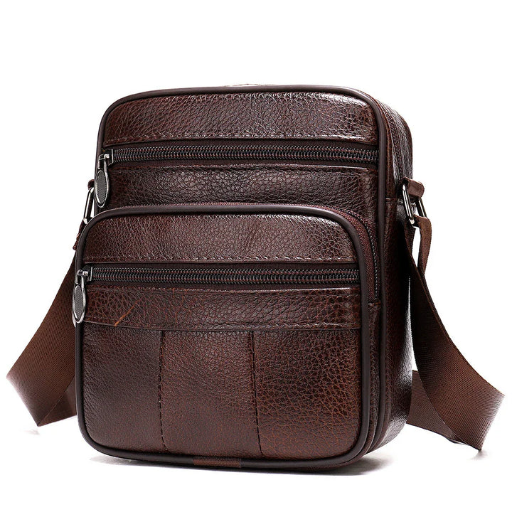 Brown textured leather crossbody bag with two zippered compartments and adjustable strap