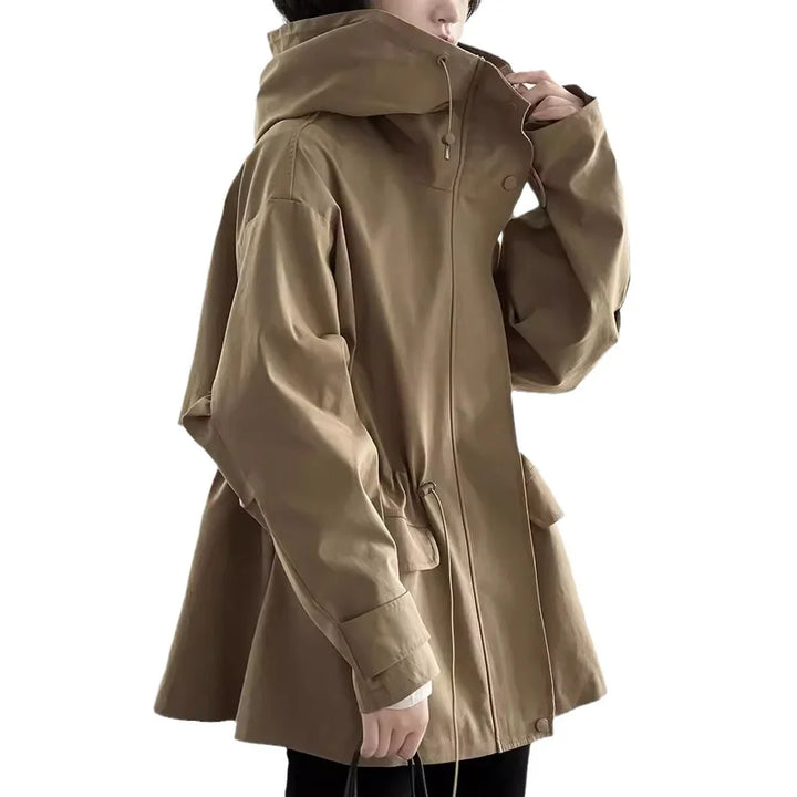 Side view of person wearing oversized beige hooded jacket with drawstring waist and long sleeves