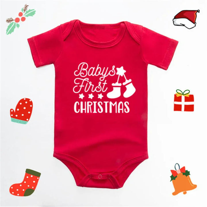 Red baby onesie with white text 'Baby's First Christmas' and Christmas-themed illustrations on white background