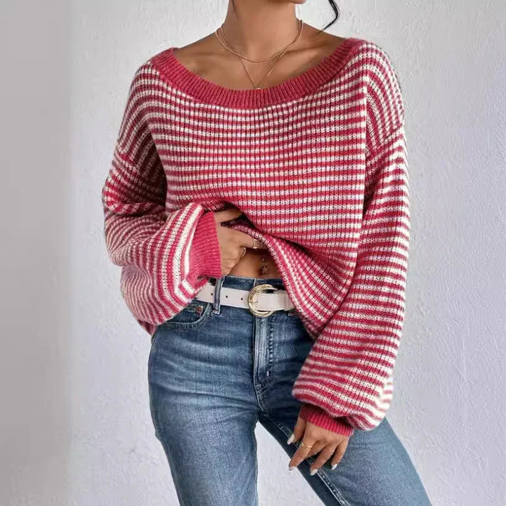 Woman wearing red and white striped oversized knit sweater with blue jeans and white belt