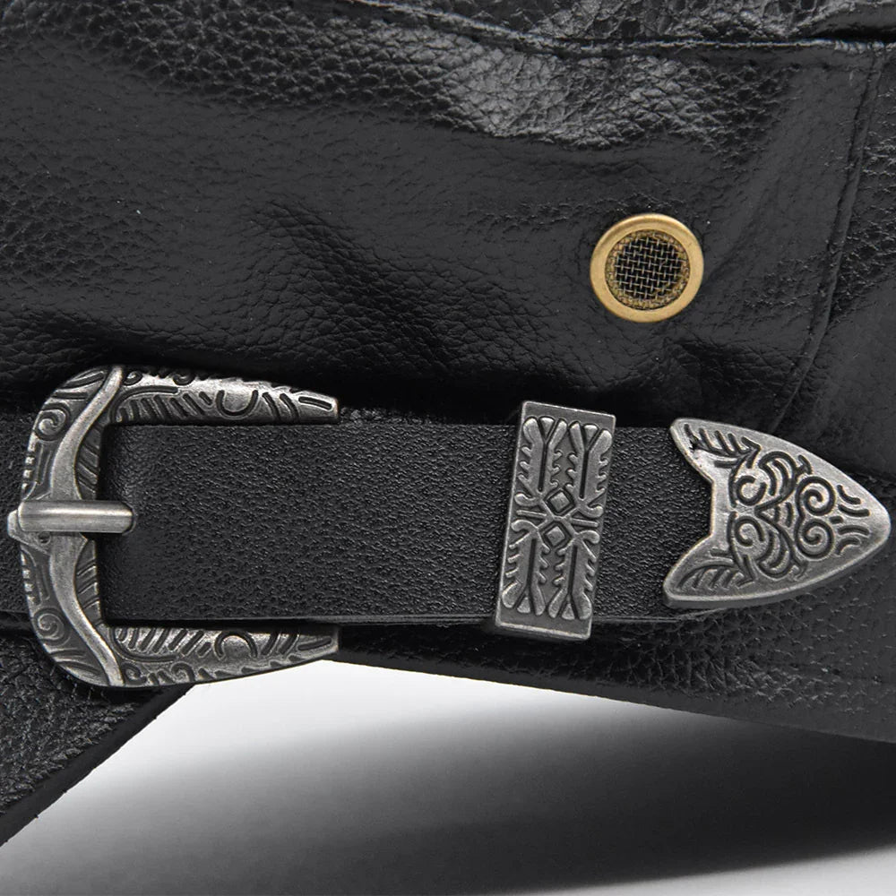Close-up of black leather bag with detailed engraved silver buckle and brass grommet