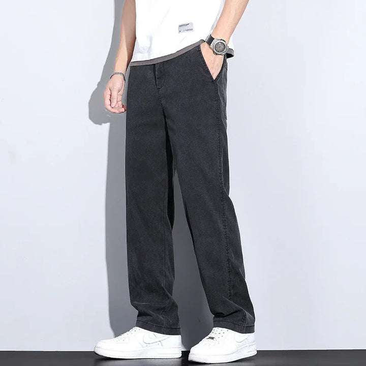 Men's casual loose-fit black pants paired with white sneakers and a white t-shirt