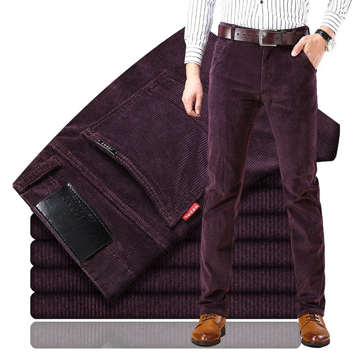 Men's dark purple corduroy pants paired with brown leather shoes and belt, folded fabric in background