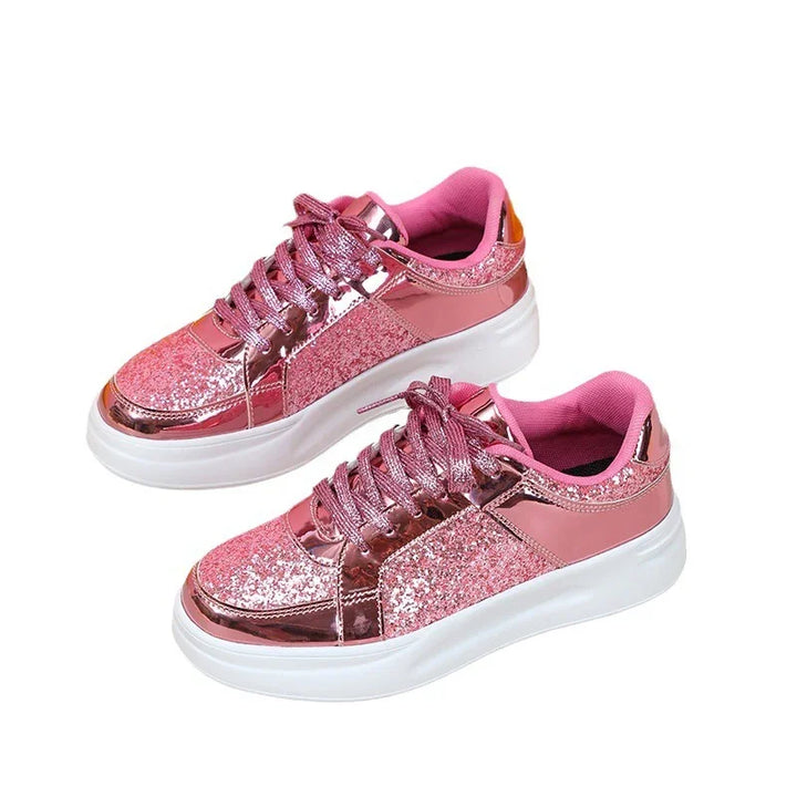 Pair of pink glittery and metallic sneakers with white chunky soles and pink laces