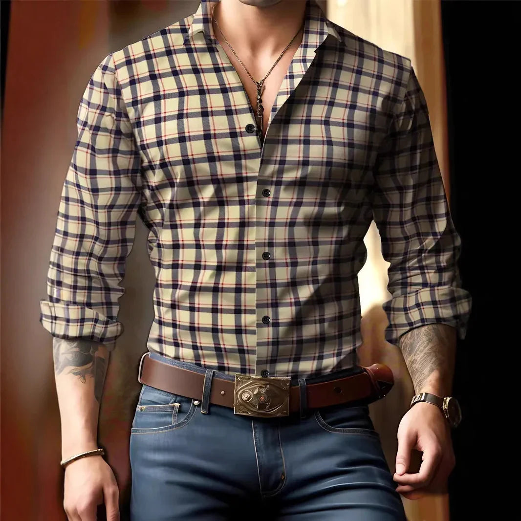 Man wearing beige checkered shirt with rolled sleeves, brown belt with decorative buckle, and blue jeans