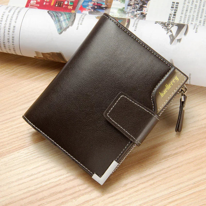 Brown leather Baellerry wallet with zipper and snap button on wooden surface with magazine background