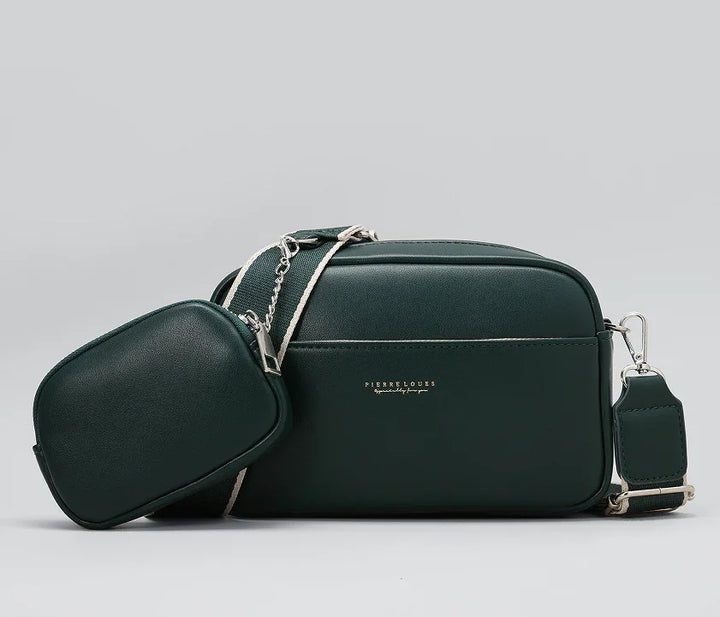 Dark green leather crossbody bag with detachable mini pouch and adjustable strap on gray background
