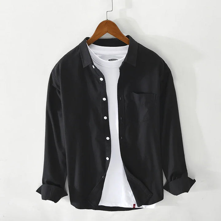 Black button-up shirt layered over white crew neck t-shirt on wooden hanger