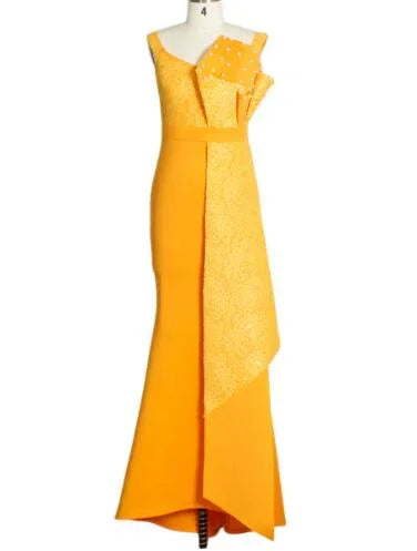 Elegant yellow evening gown with asymmetrical lace overlay and bow detail on mannequin