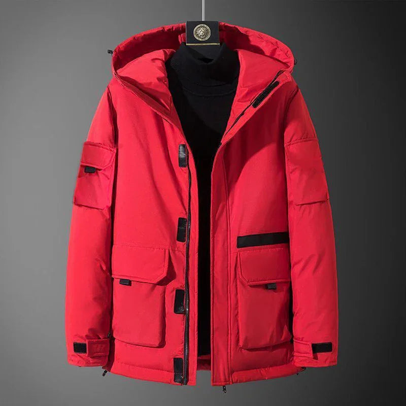 Red winter jacket with multiple pockets and a hood, displayed on a black mannequin