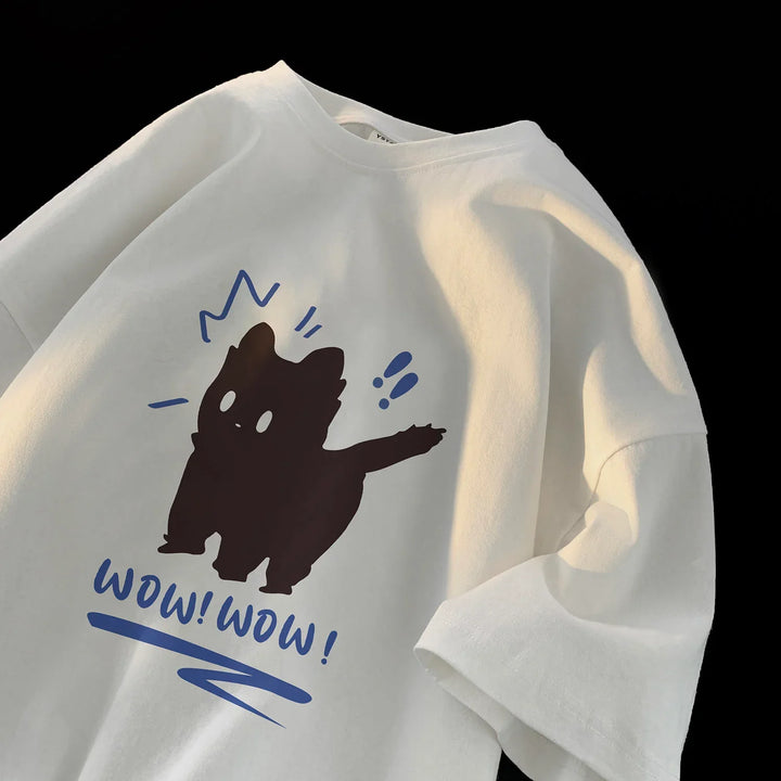 White T-shirt with black cat cartoon and blue text saying WOW! WOW! under bright lighting