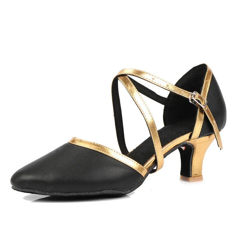 Black and gold women's dance shoe with low heel and cross straps on white background