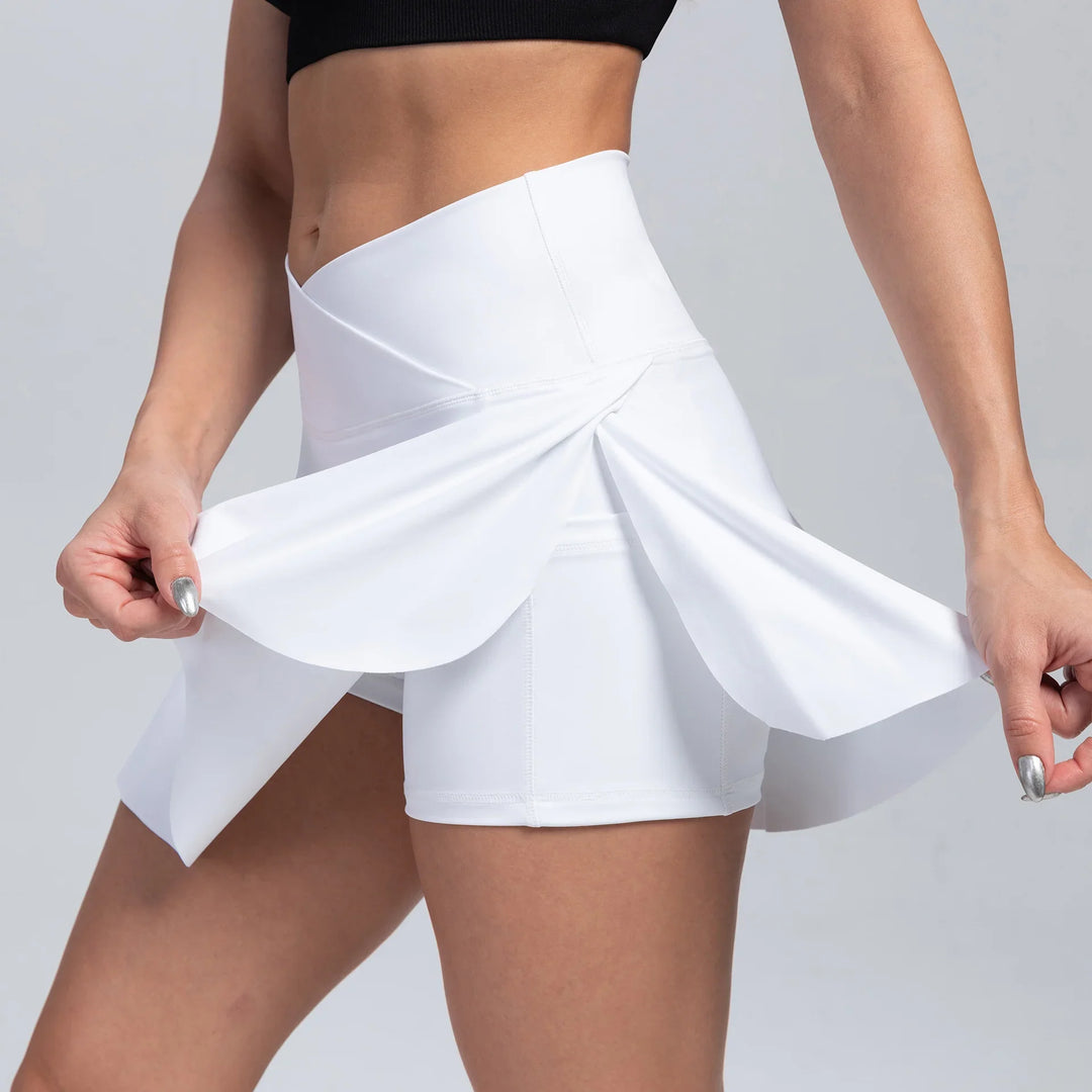 Woman wearing white high-waisted athletic skort showing stretch fabric detail