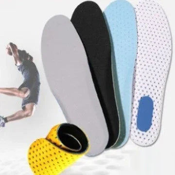 Set of colorful shoe insoles including grey, black, blue, and white with blue heel pad against a sports background