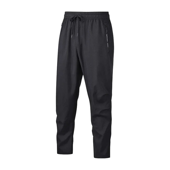 Men's black casual jogger pants with drawstring waistband and zippered side pockets