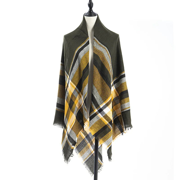 Plaid shawl in mustard yellow, olive green, black, and white on mannequin