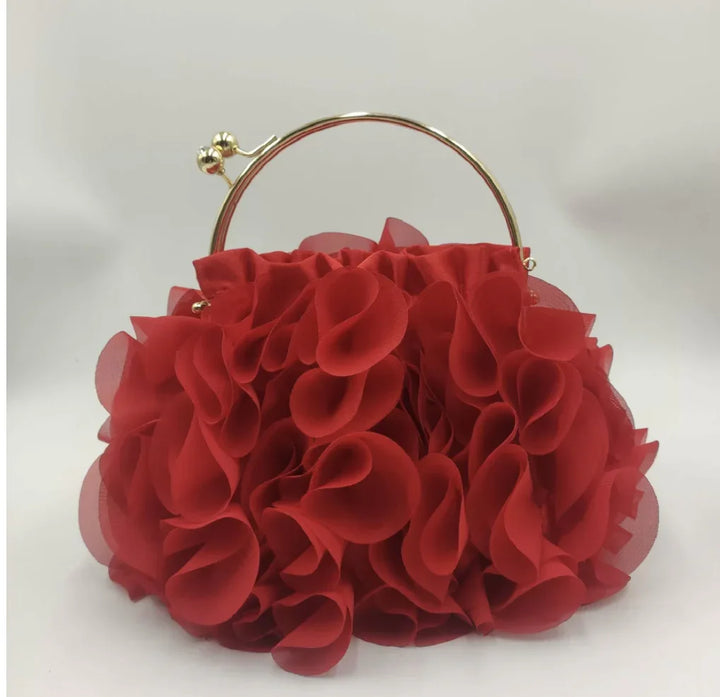 Red textured flower petal clutch purse with gold metal circular handle on white background