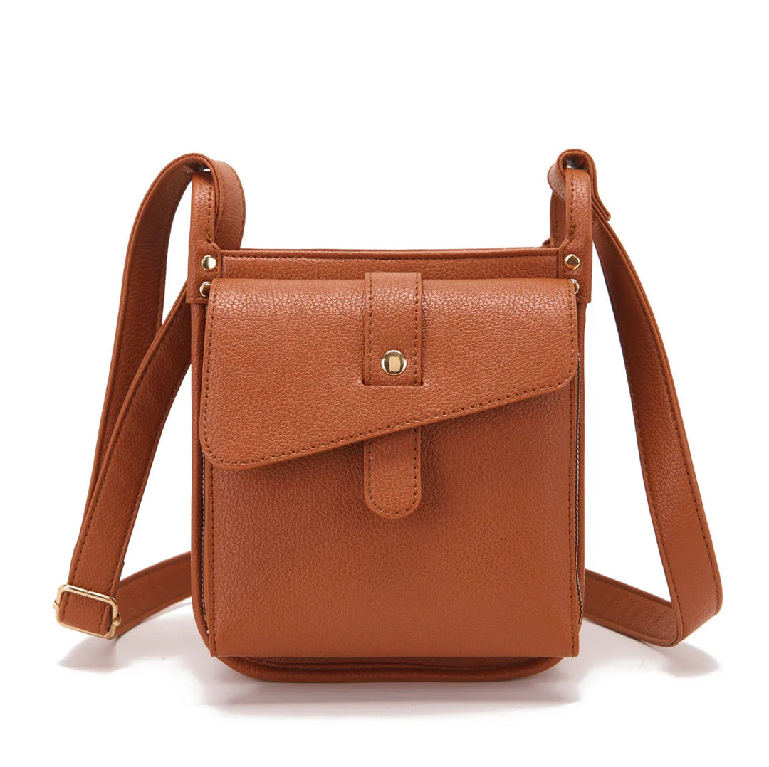 Brown faux leather crossbody bag with front flap pocket and adjustable strap