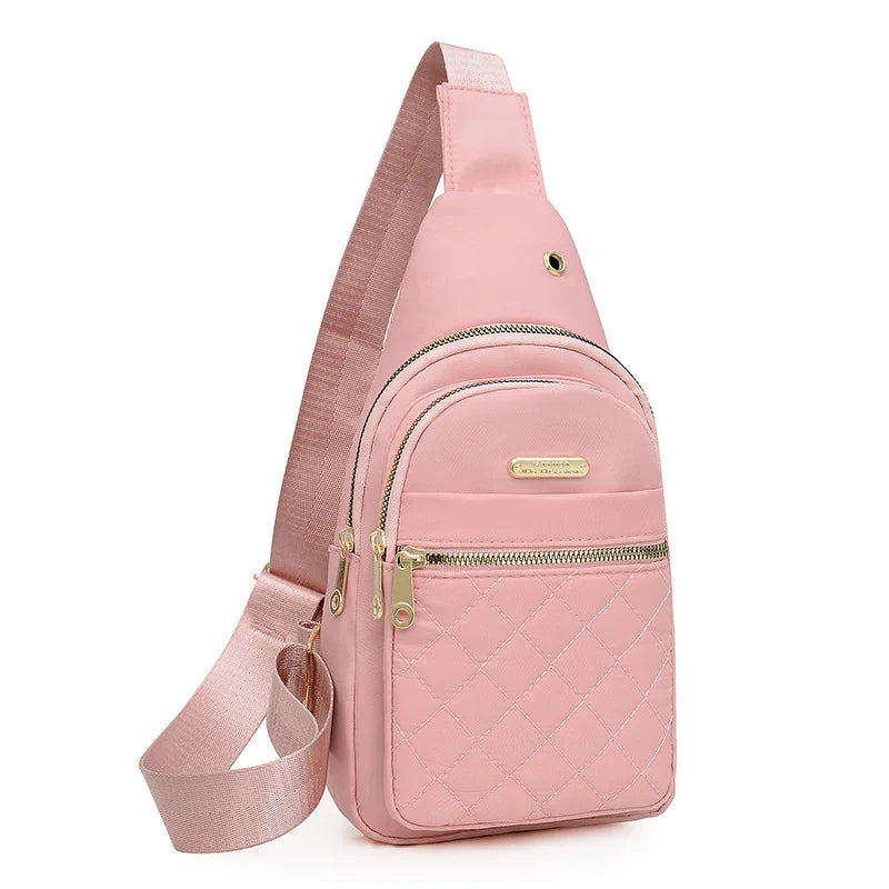 pink quilted sling bag with gold zippers and adjustable shoulder strap