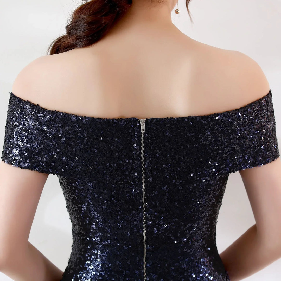 Back view of woman wearing off-shoulder black sequin dress with zipper closure