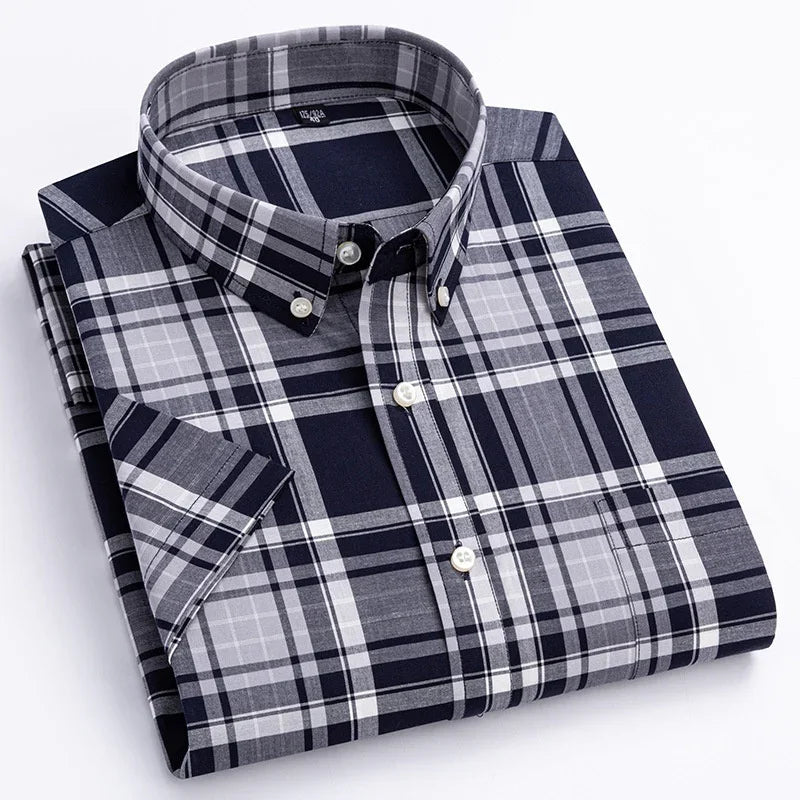 Folded navy blue and grey plaid short sleeve button-down shirt with white buttons