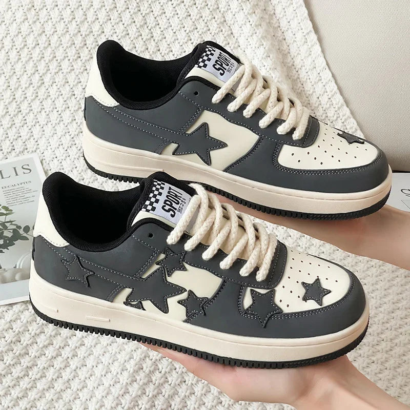 Black and white star-patterned sneakers with thick white laces and black soles on knit fabric