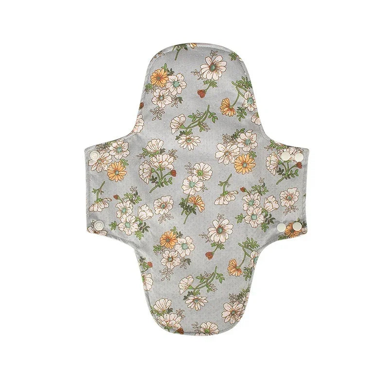 Reusable cloth menstrual pad with grey background and white and yellow floral pattern
