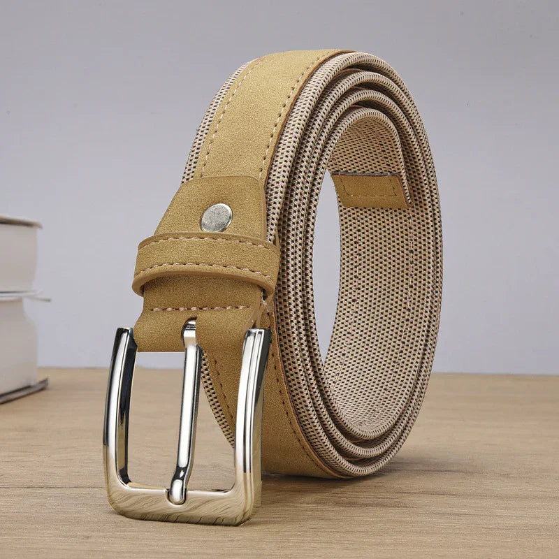rolled tan leather belt with silver buckle on wooden surface and blurred books background