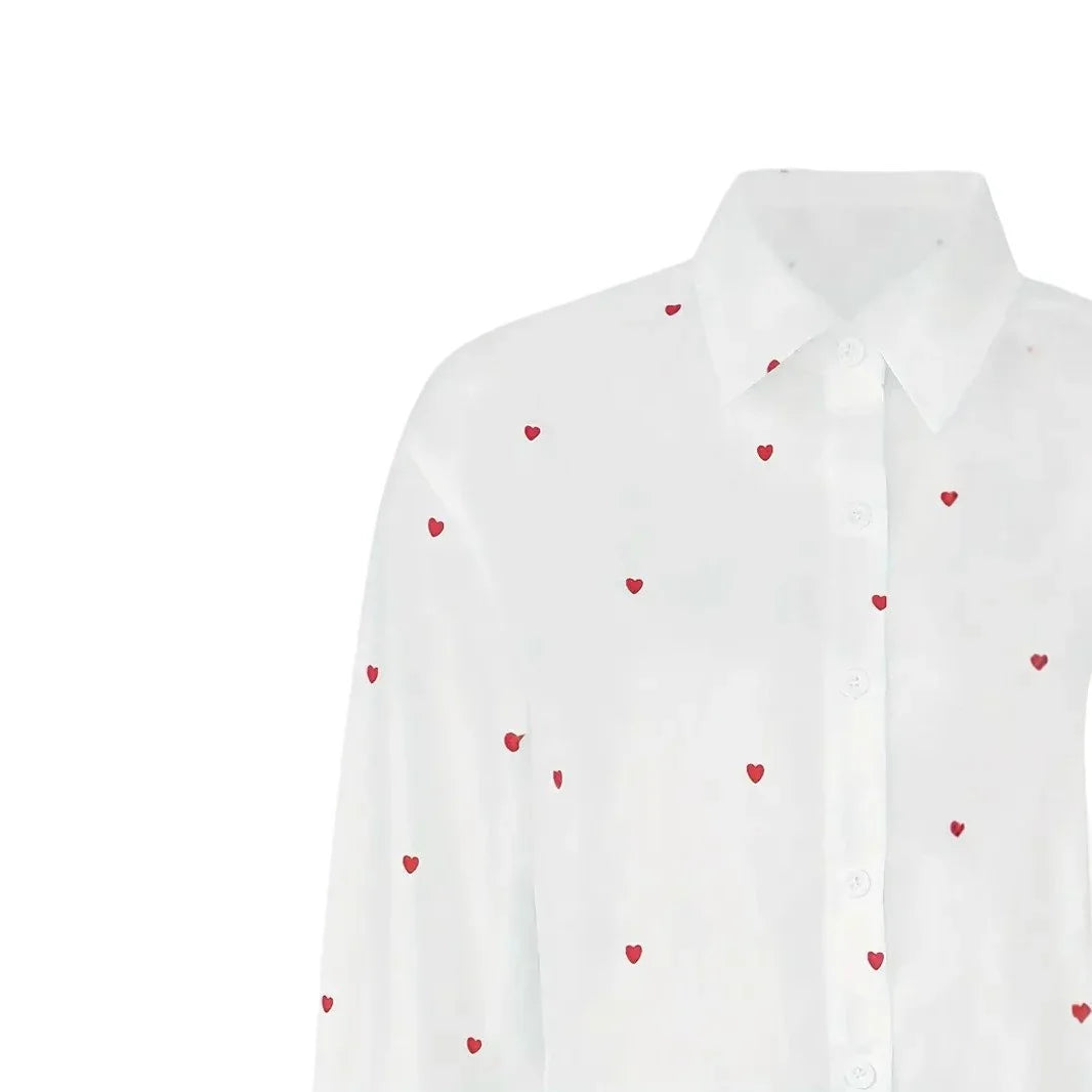 White button-up shirt with small red heart prints, classic collar, and long sleeves
