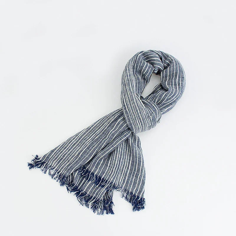 Blue and white striped lightweight scarf with fringed edges on white background