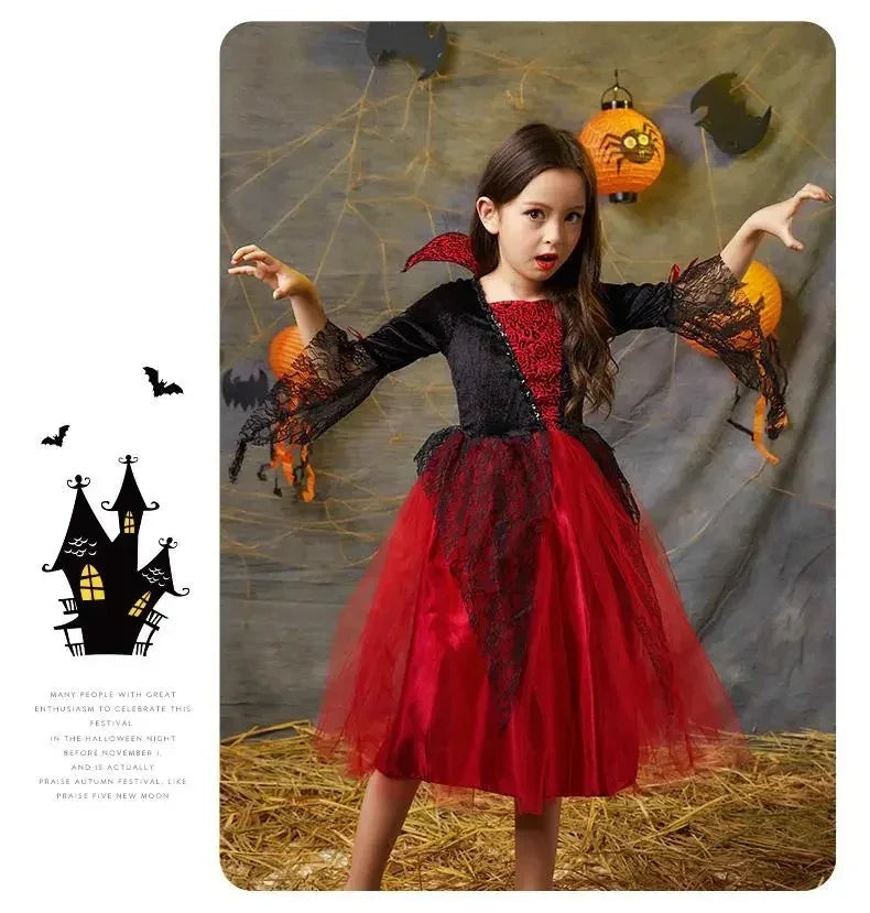 Young girl in red and black spider web Halloween costume dress posing with spooky decorations