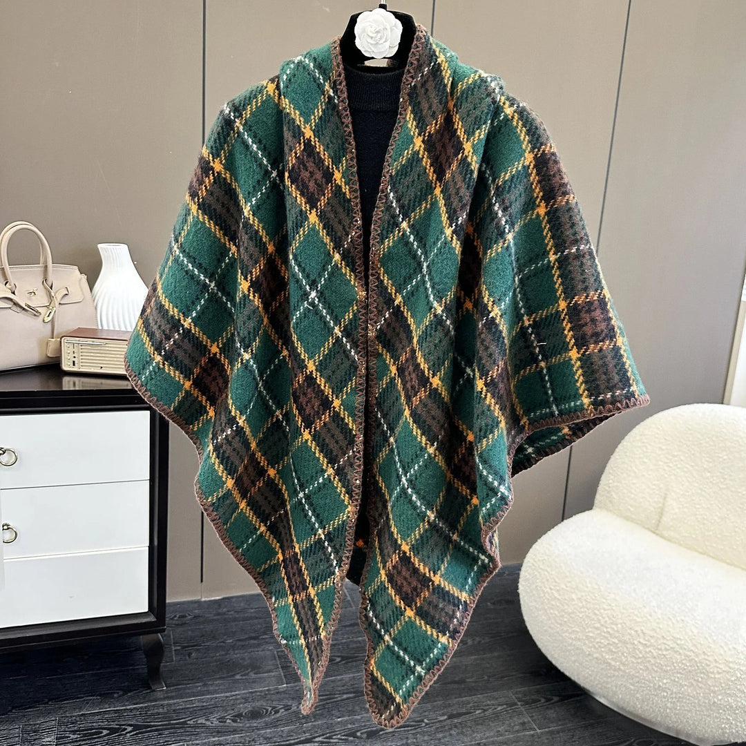 Green and brown plaid wool cape with yellow and white lines displayed on a black mannequin