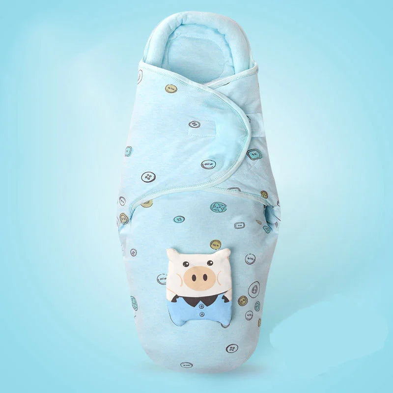 Light blue baby swaddle with button pattern and cute pig face plush on front