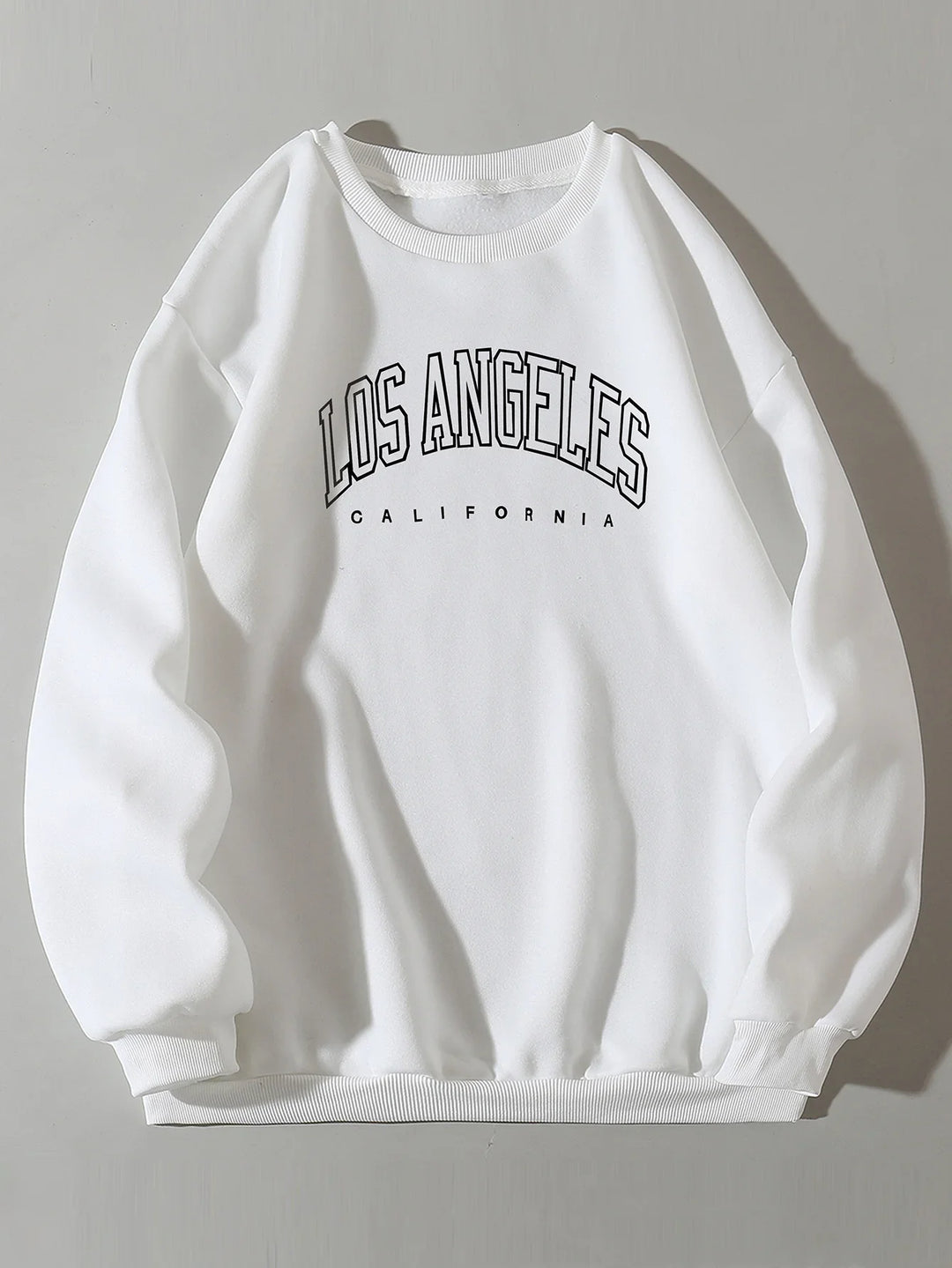 White sweatshirt with black 'Los Angeles California' text printed on front, casual cotton pullover