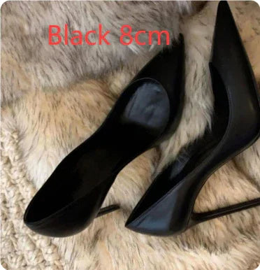 Pair of black 8cm high heel stiletto shoes on beige fur surface