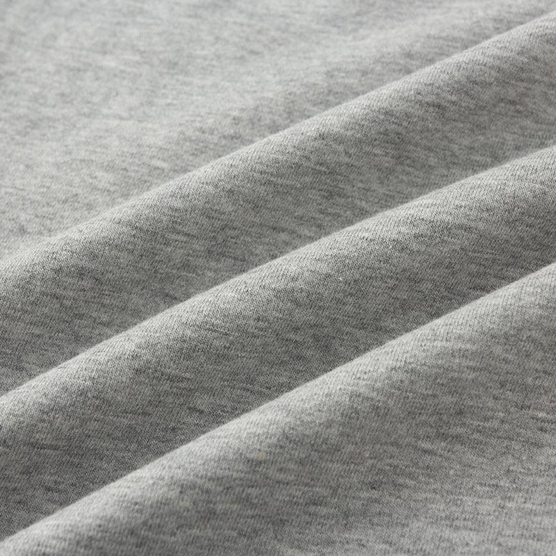 Close-up of soft, heather gray cotton fabric with folded texture