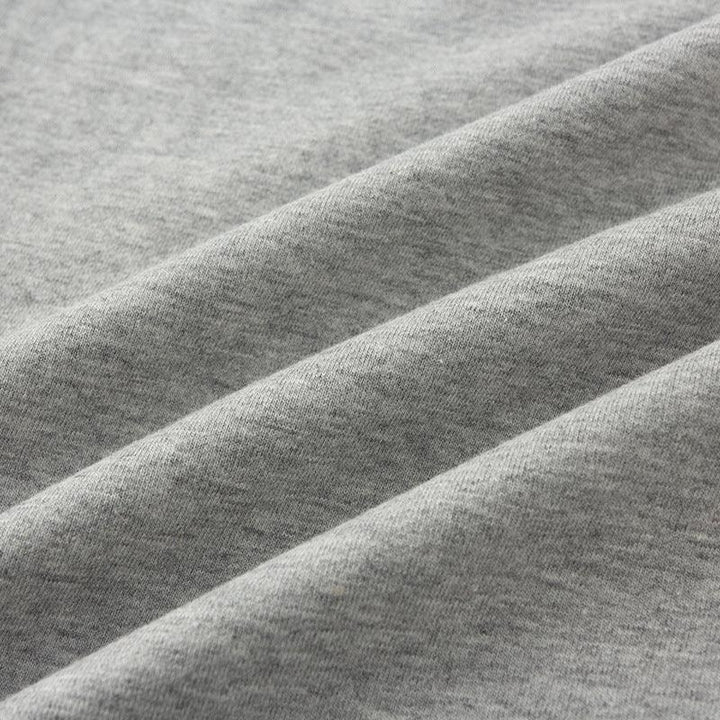 Close-up of soft, heather gray cotton fabric with folded texture