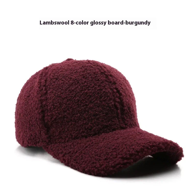 Burgundy lambswool baseball cap with glossy textured fabric on white background