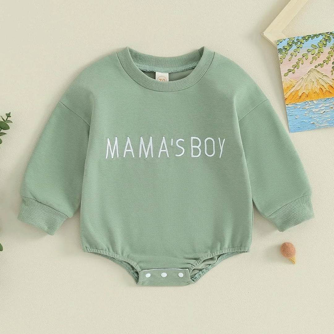 Green baby romper with long sleeves and white text reading MAMA'S BOY on front