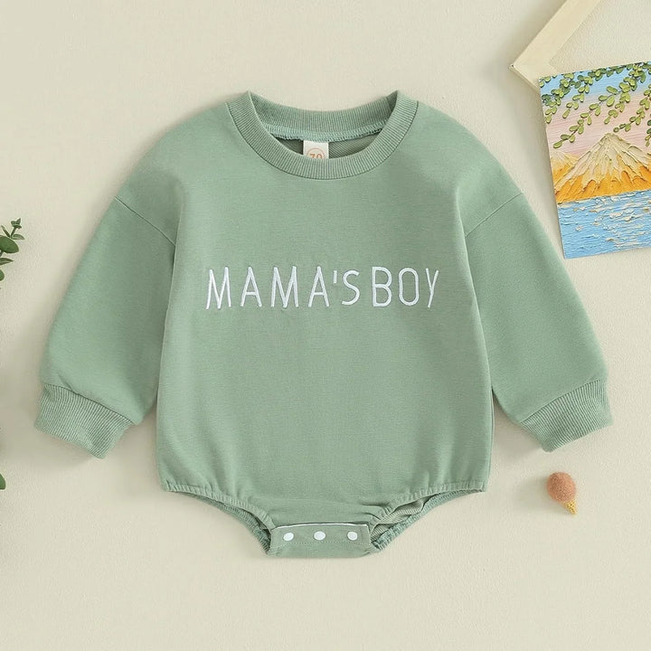 Green baby romper with long sleeves and white text reading MAMA'S BOY on front