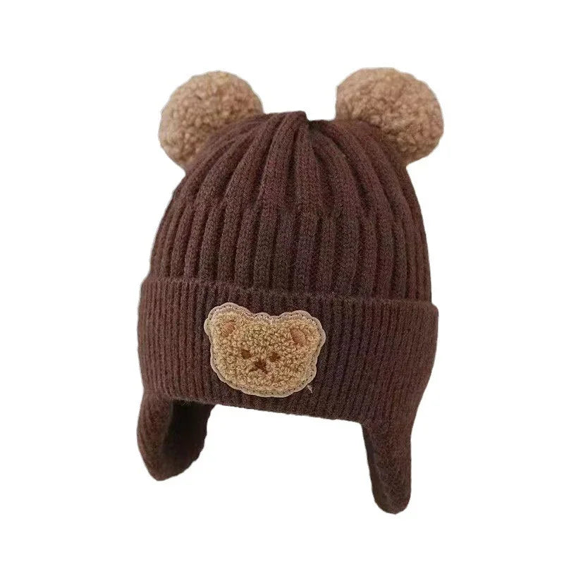 Brown knitted winter hat with bear ears and a teddy bear patch on front