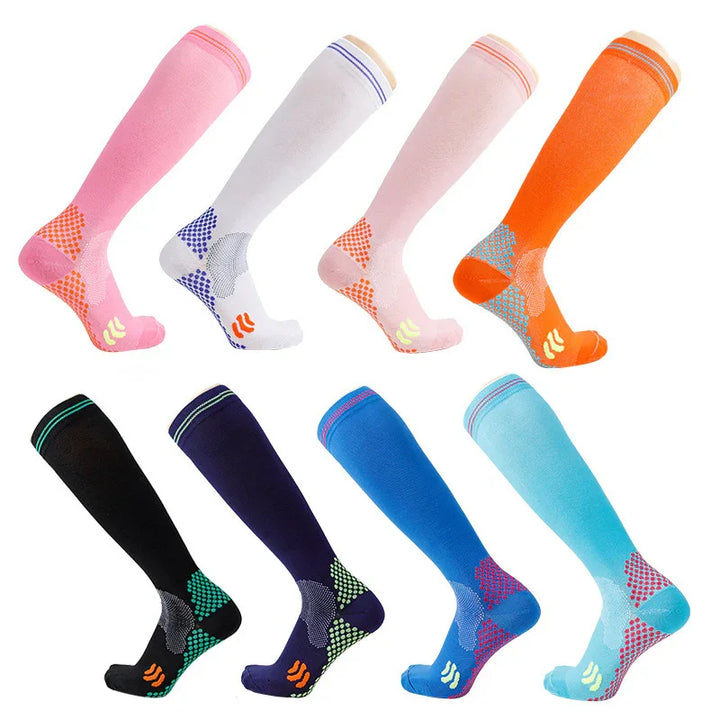 Eight pairs of colorful knee-high compression socks in pink, white, orange, black, navy, blue, and teal with grip patterns