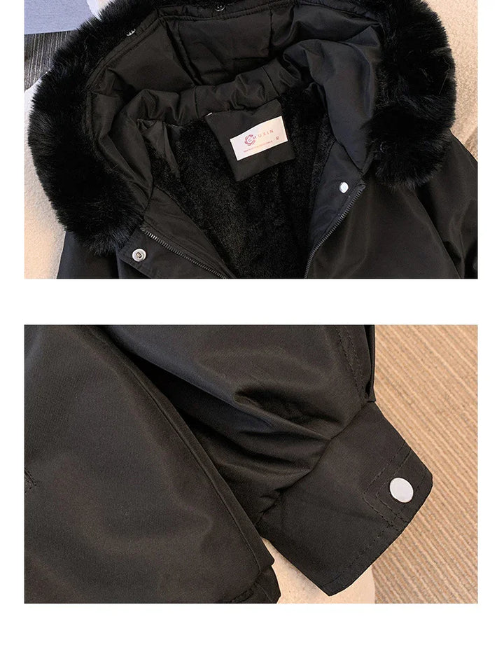 Black winter jacket with faux fur hood trim and buttoned cuff detail on sleeve