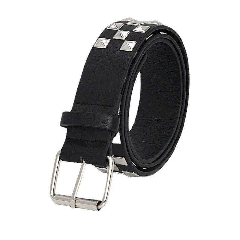 Black leather belt with silver pyramid studs and a silver buckle, rolled up on white background