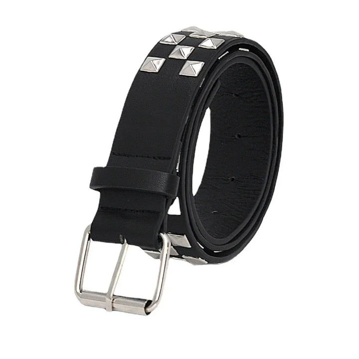 Black leather belt with silver pyramid studs and a silver buckle, rolled up on white background