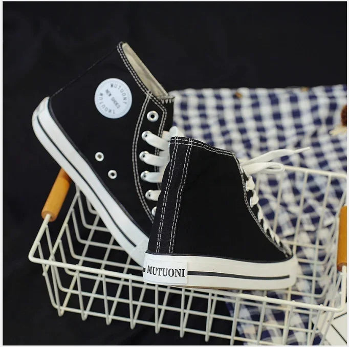 Black high-top canvas sneakers with white laces and MUTUONI branding in a white wire basket
