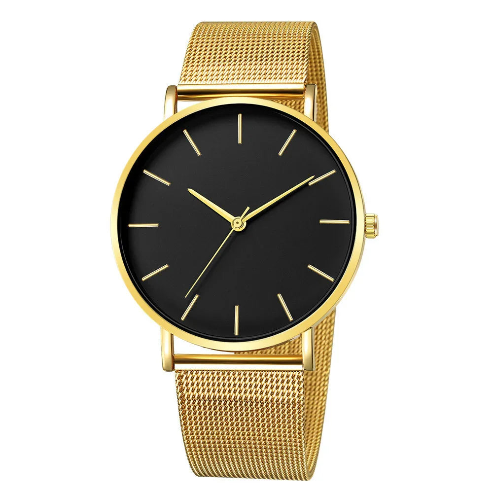 Gold mesh band wristwatch with black minimalist dial and gold hour markers and hands